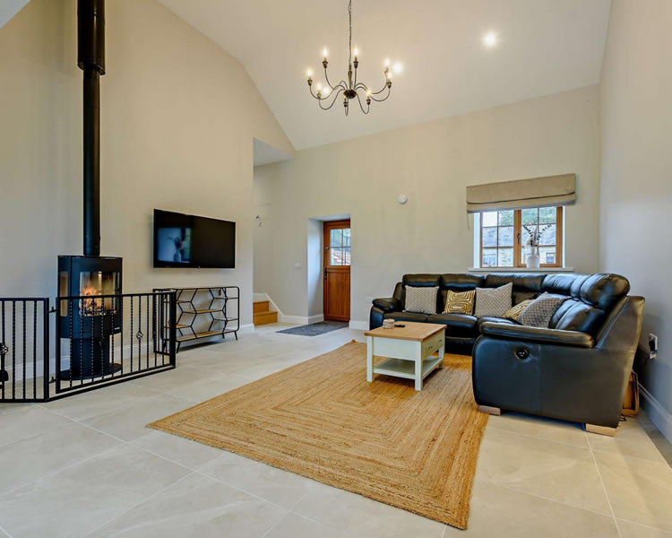 Open-plan lounge and kitchen at Y Beudy